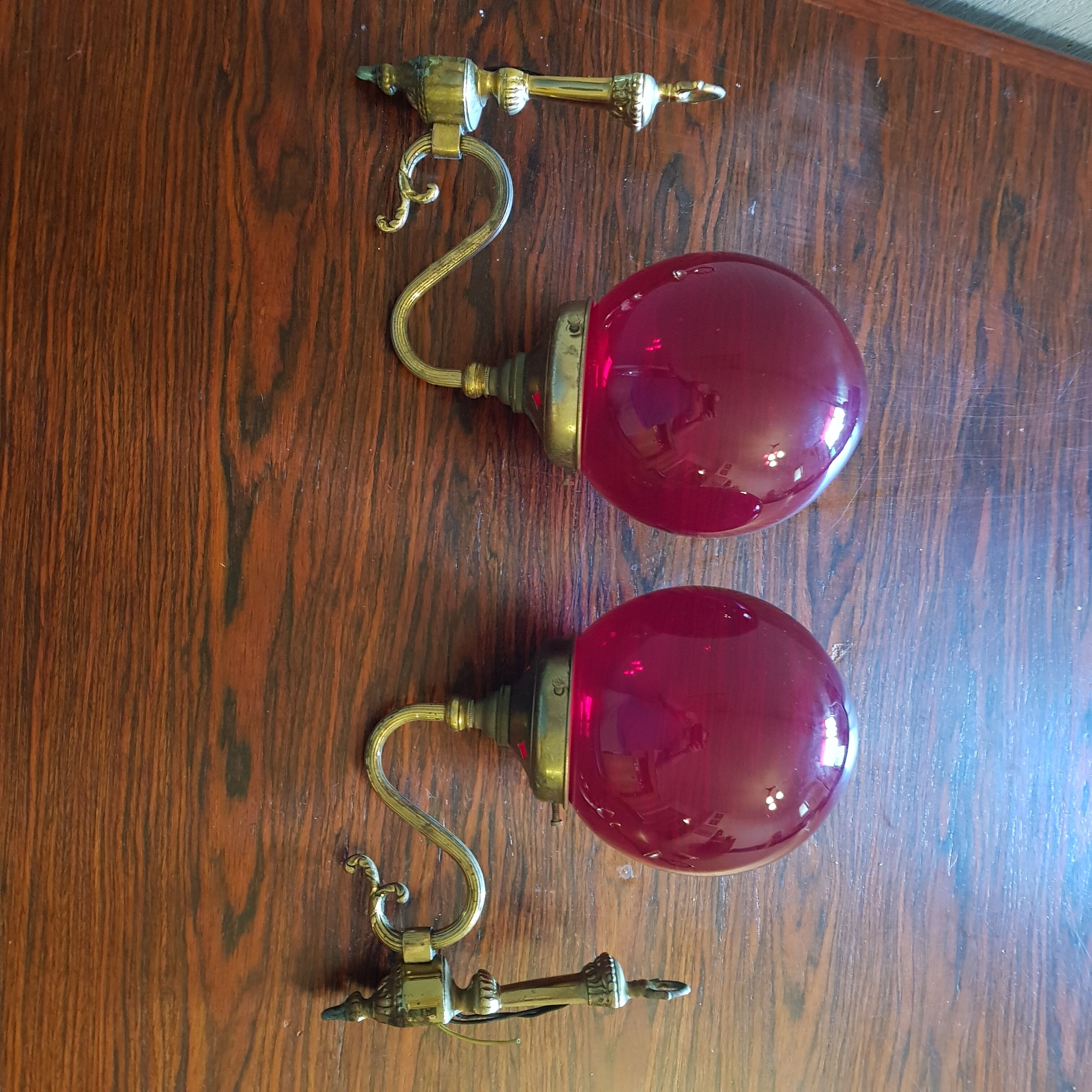 Pair of vintage brass wall light and cherry red globe