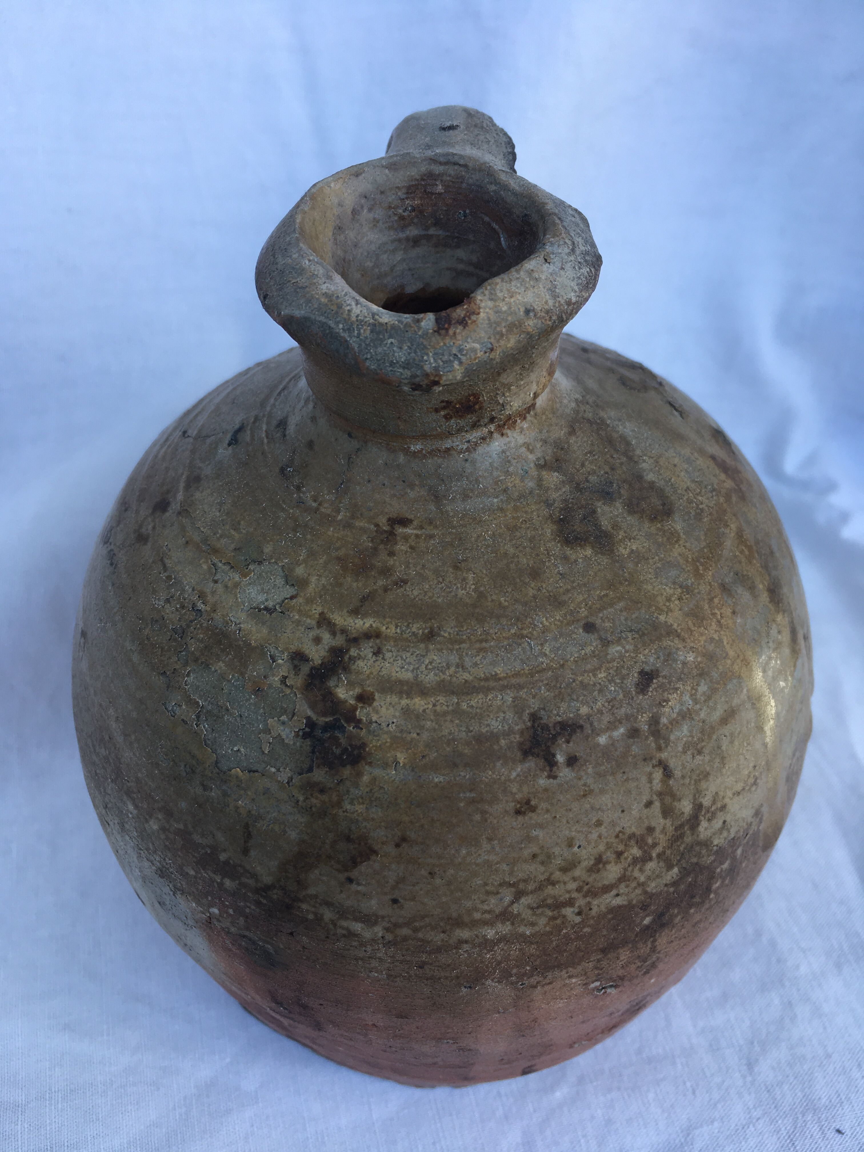 Ancient jug in glazed sandstone