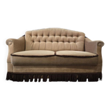 Vintage beige two-seater canapé with fringes.