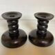 Pair of black stained wooden candlesticks