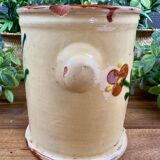 Antique ceramic pot with hand-painted floral decoration.
