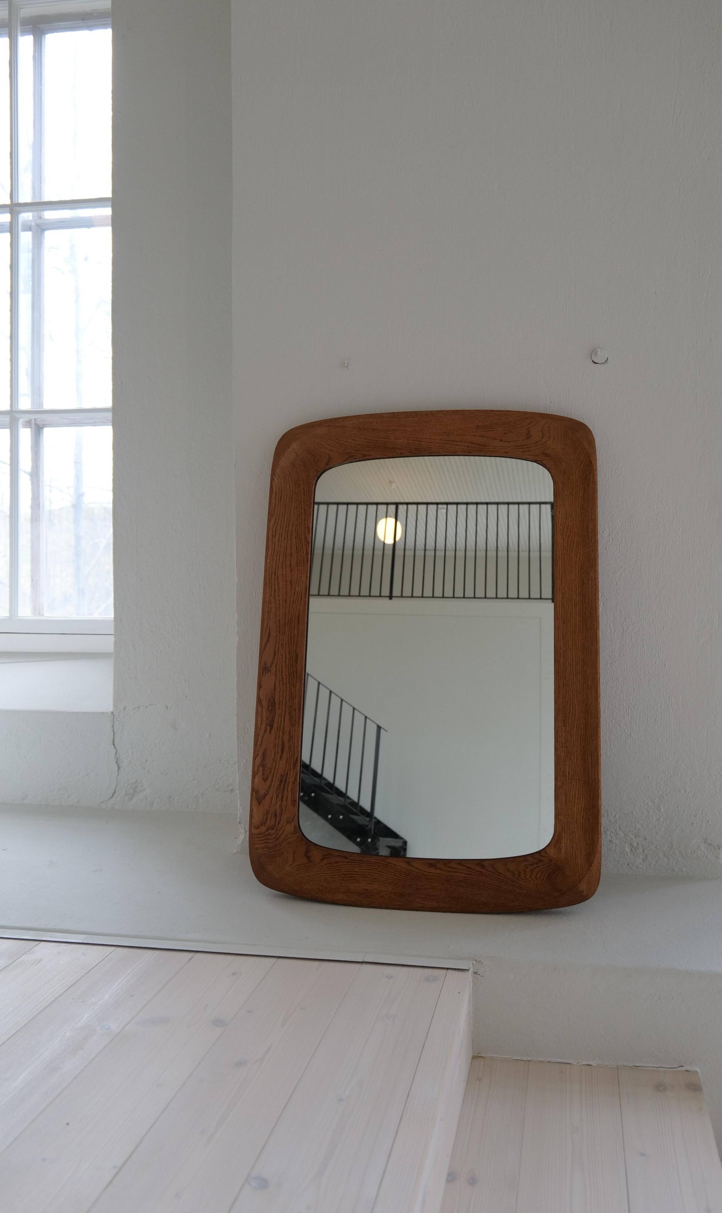 Mid-century modern sculptural wall mirror in stained oak, glass, Glas & Trä 1959