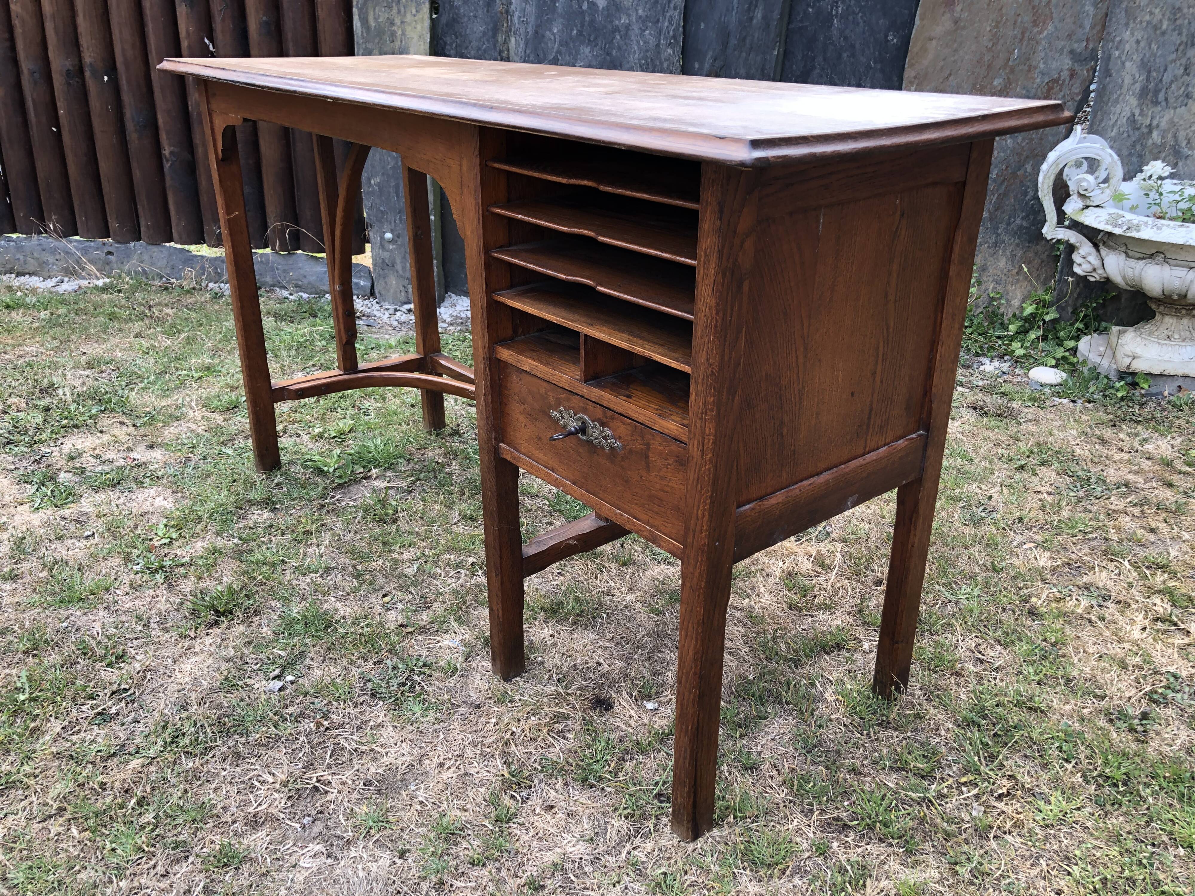 Old oak desk with curved wooden sleepers in the Art Nouveau spirit of the early 20th century.