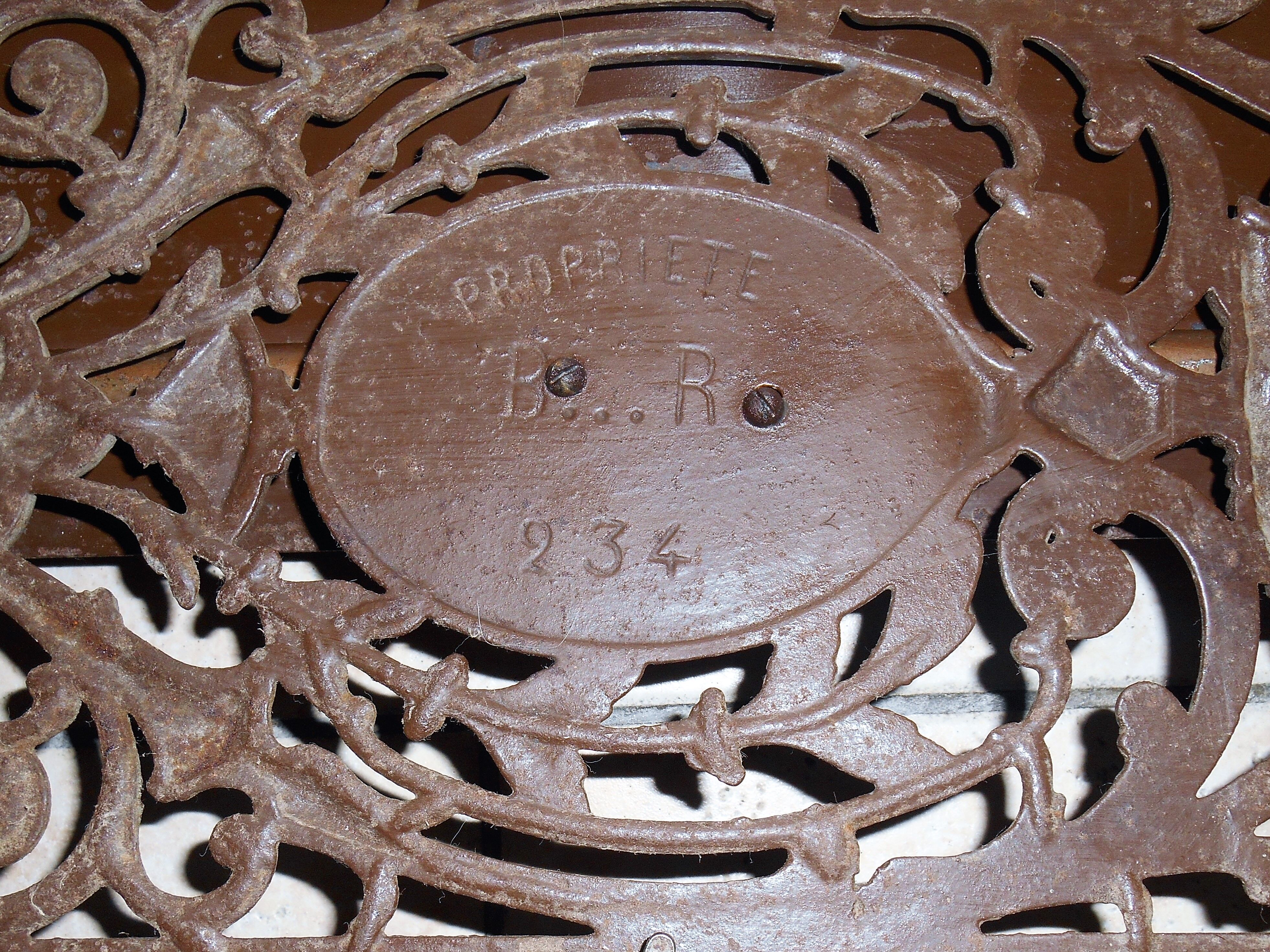 Pair of cast iron door grilles with its coat