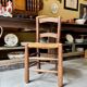 Provençal chair in dark wood and woven straw.