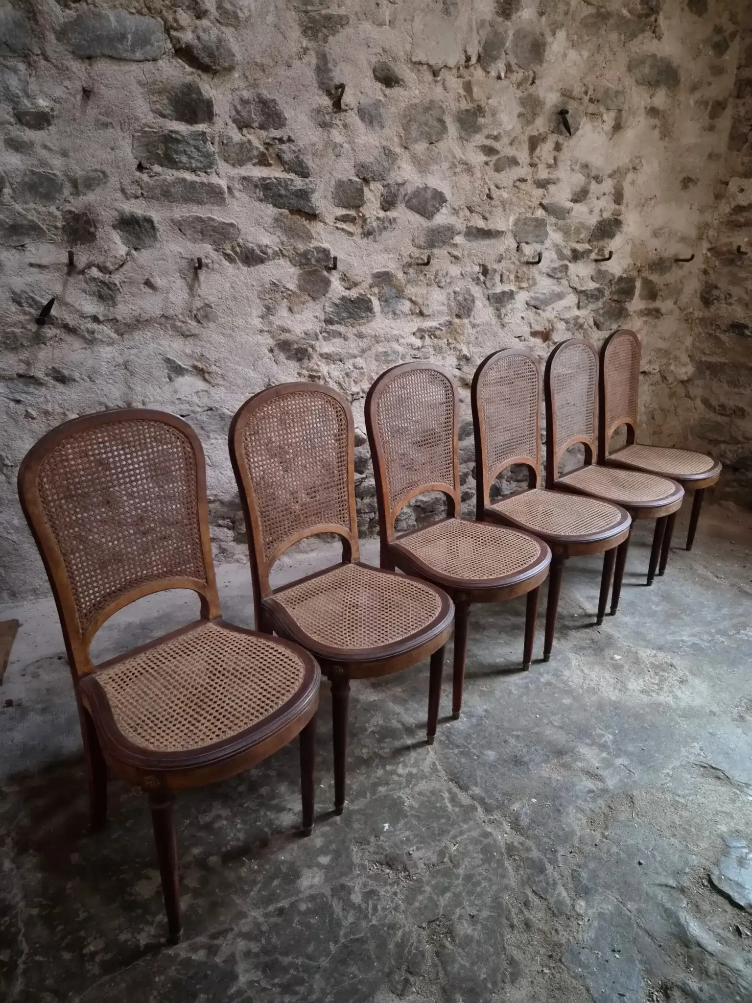 Set of 6 antique Louis XVI style dining chairs with caning.