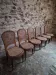 Set of 6 antique Louis XVI style dining chairs with caning.
