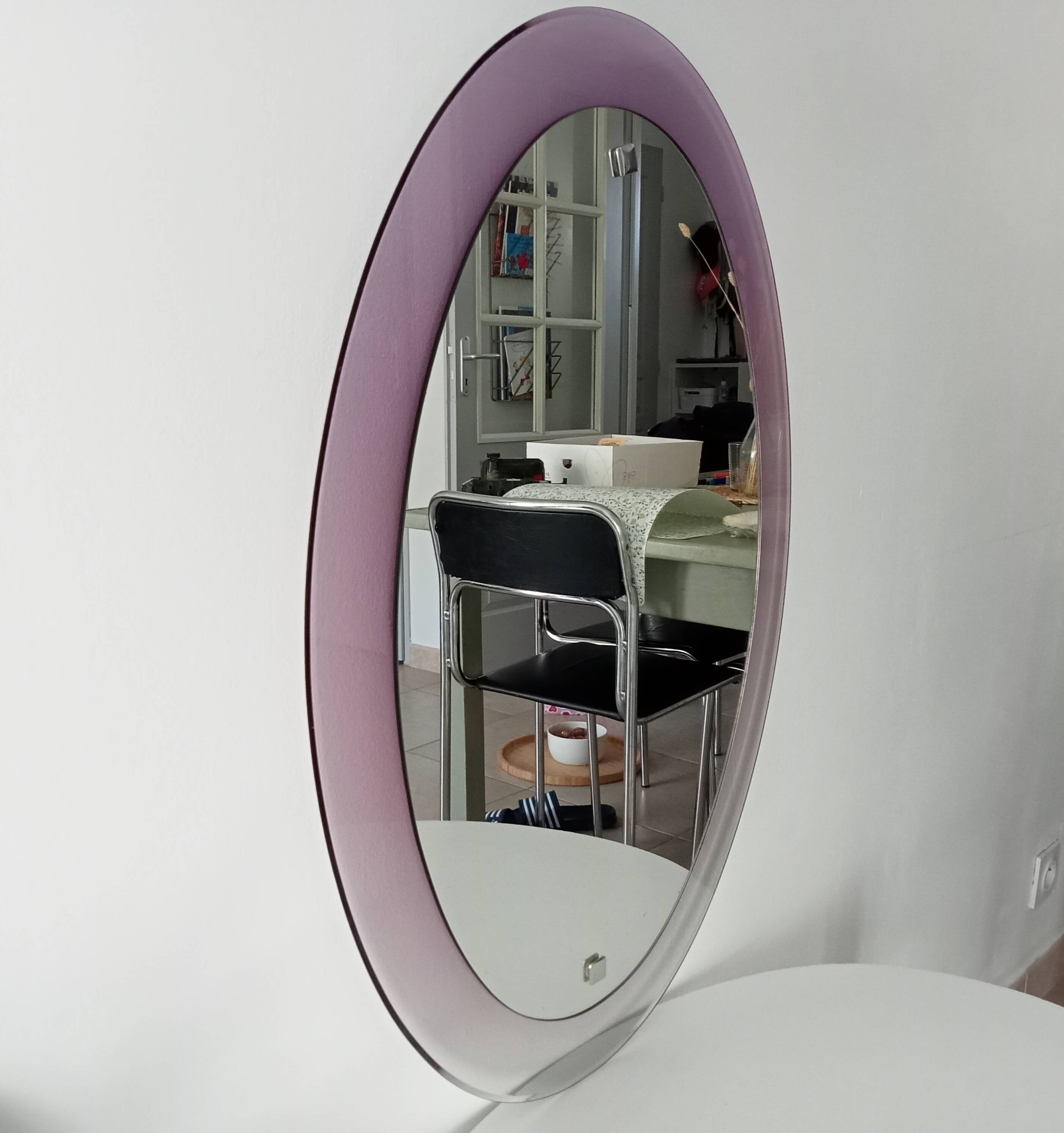 Vintage oval plexiglass mirror from the 70s by Harvey Guzzini