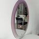 Vintage oval plexiglass mirror from the 70s by Harvey Guzzini