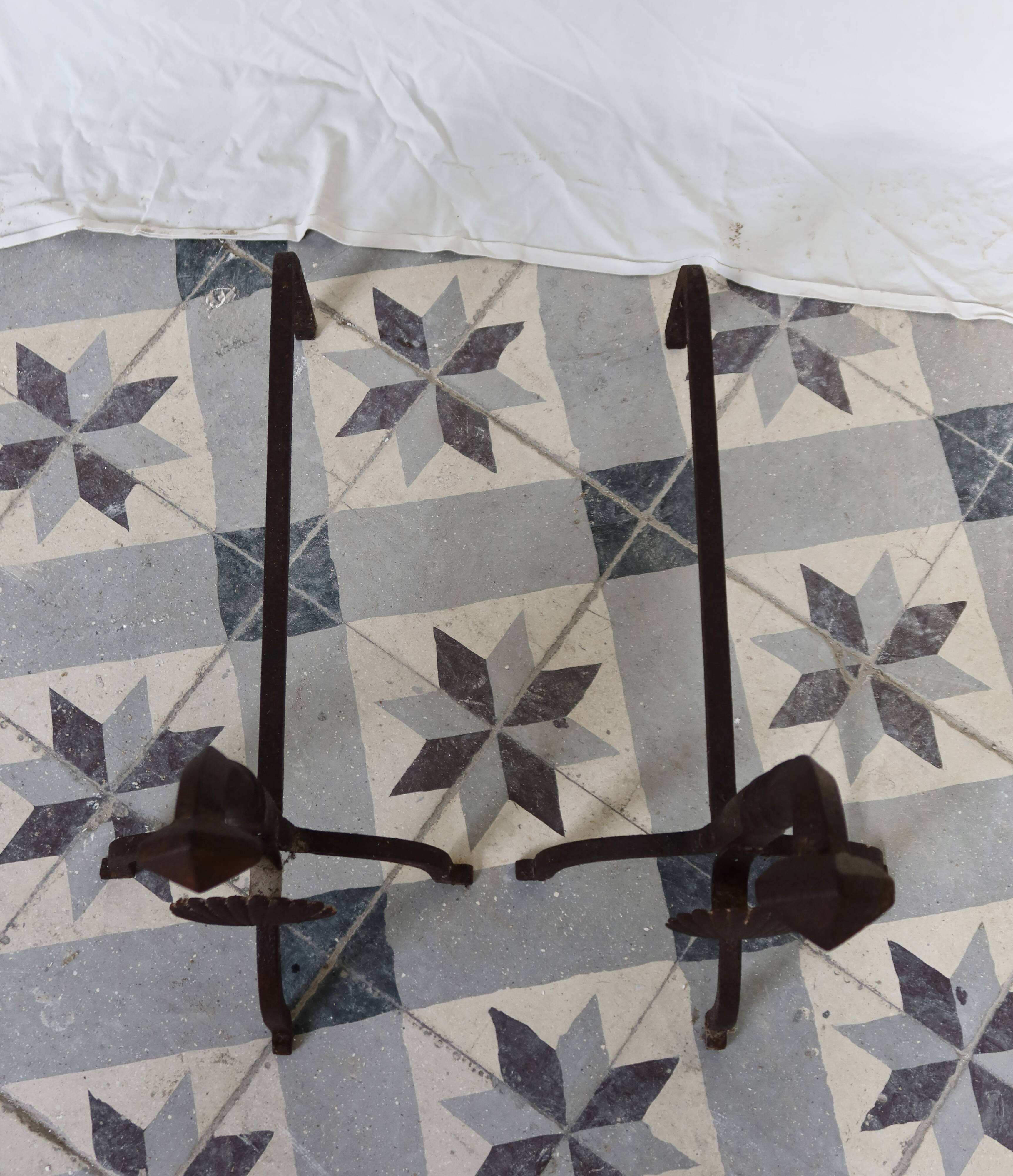 Vintage metal and cast iron fire dogs with shell motif.