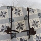 Vintage metal and cast iron fire dogs with shell motif.