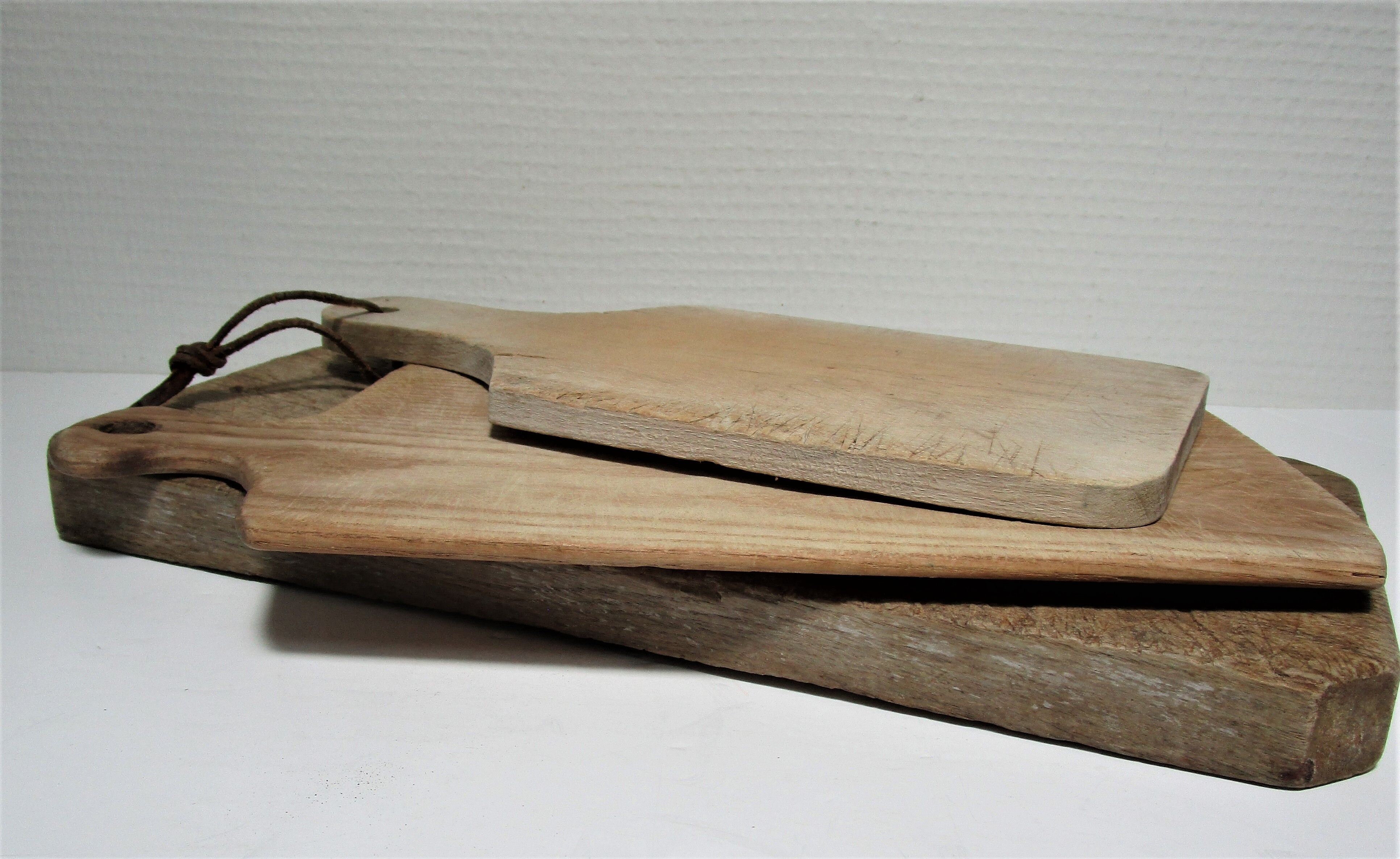 three vintage patinated solid wood cutting boards