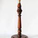 Table lamp with a carved wooden base and pleated lampshade