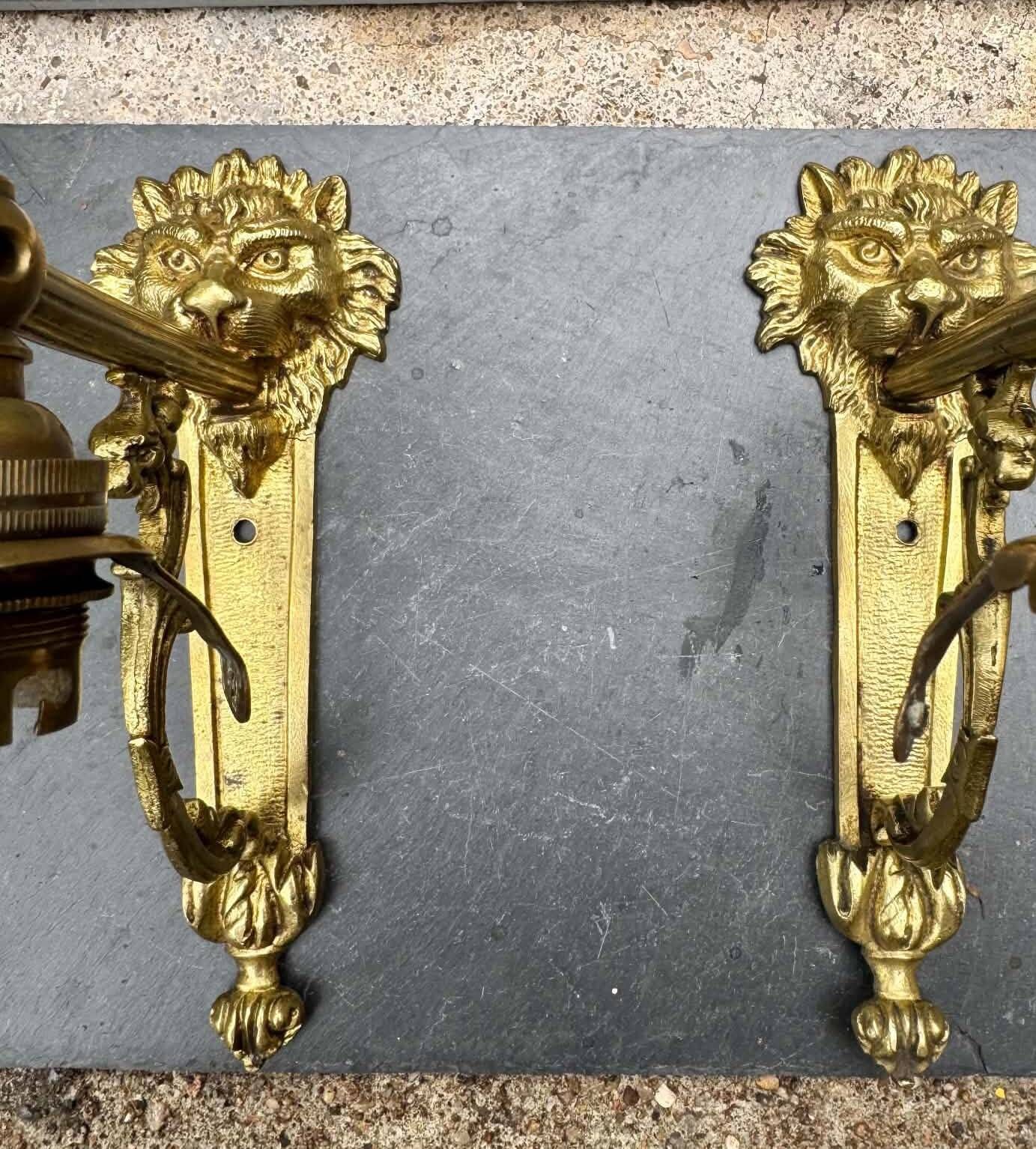 2 brass lion Empire wall sconces