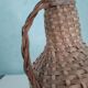 Bottle in his suit of wicker