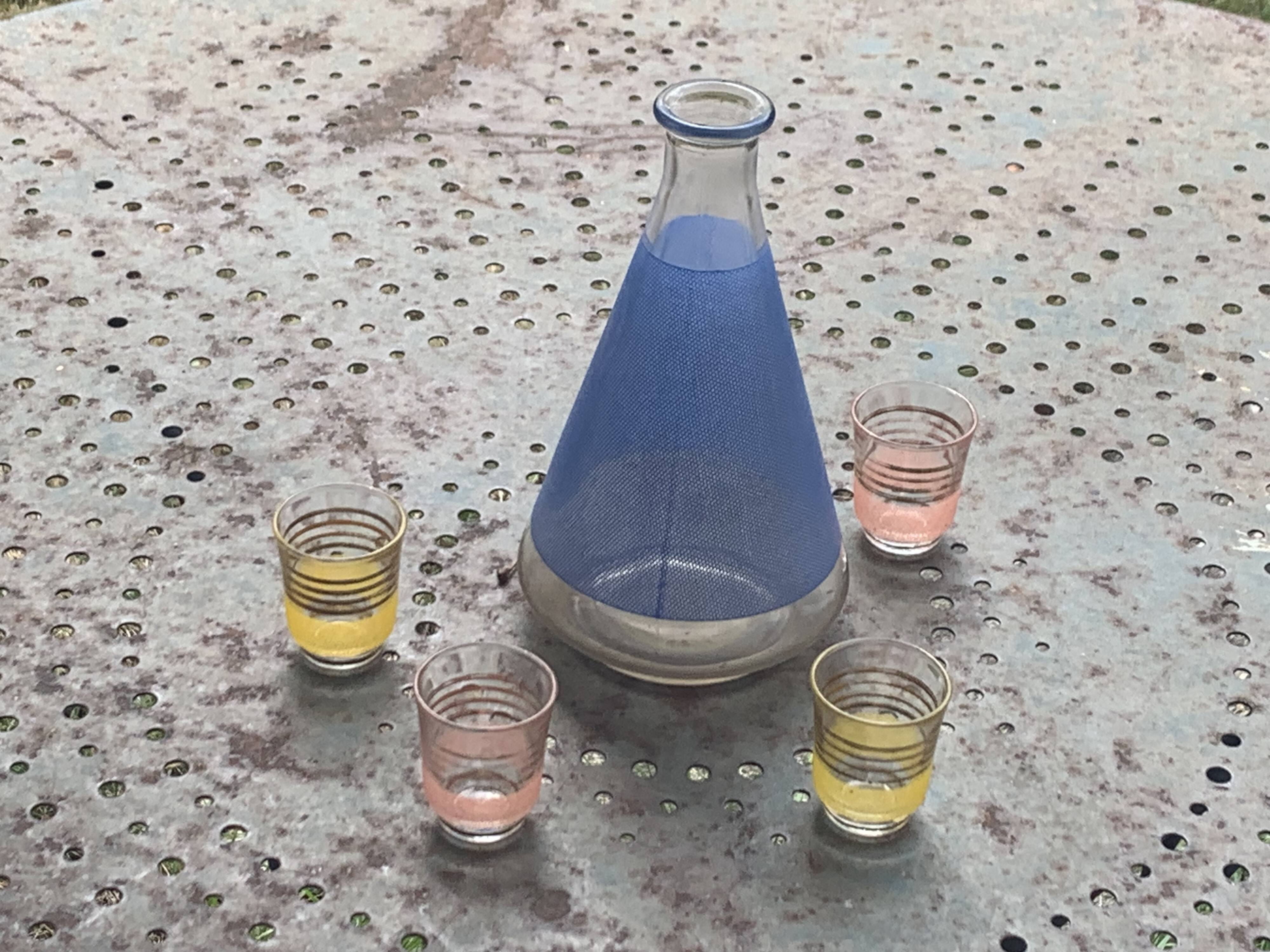 Blue glass liqueur carafe and 4 small vintage granite glasses