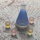 Blue glass liqueur carafe and 4 small vintage granite glasses