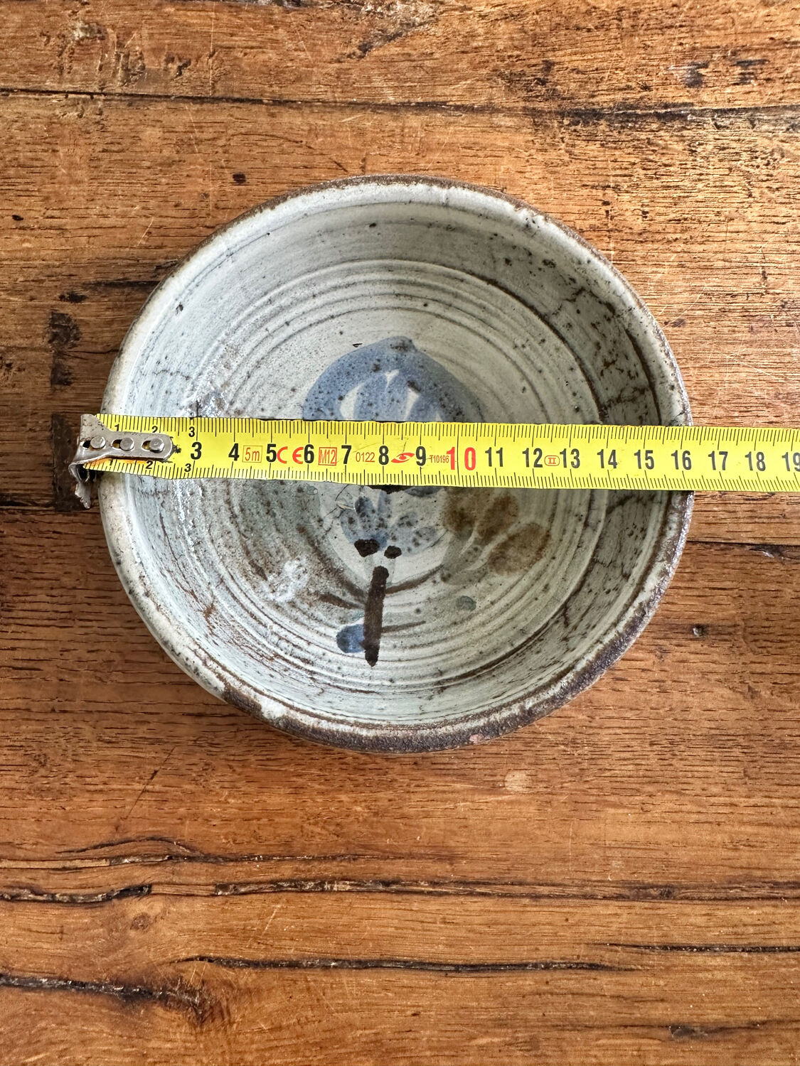 Enamelled red earth cup decorated with flowers. Gustave Reynaud.