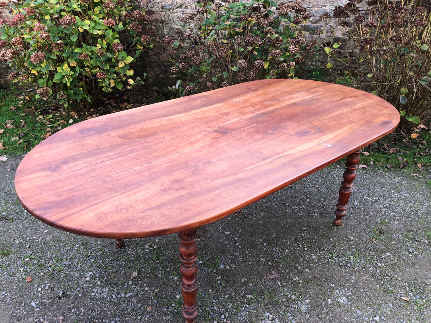 Antique cherry wood farmhouse table with rounded ends
