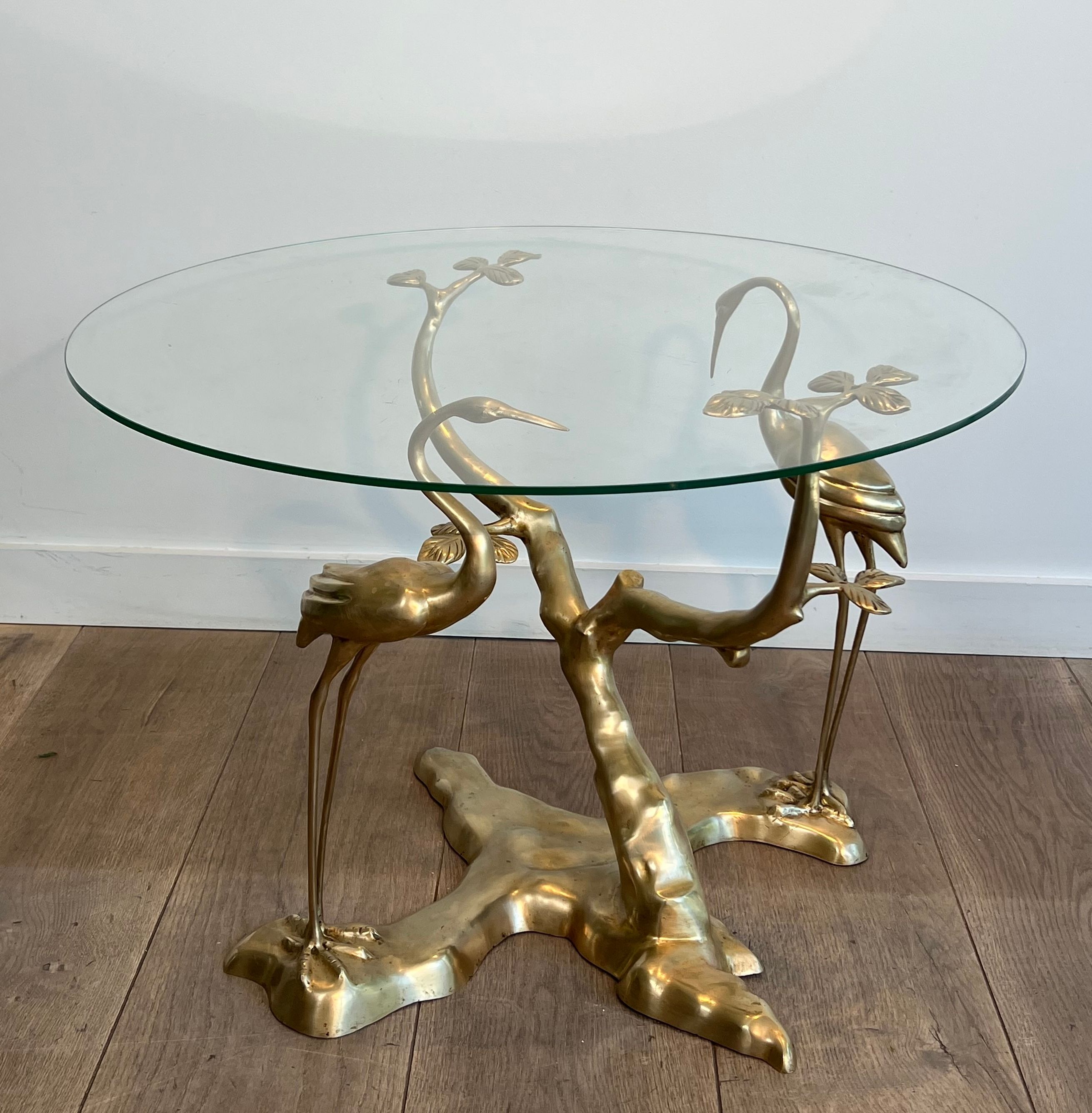 Coffee table model with cranes surrounding a brass bonsai and round glass top by Willy Daro.