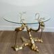 Coffee table model with cranes surrounding a brass bonsai and round glass top by Willy Daro.
