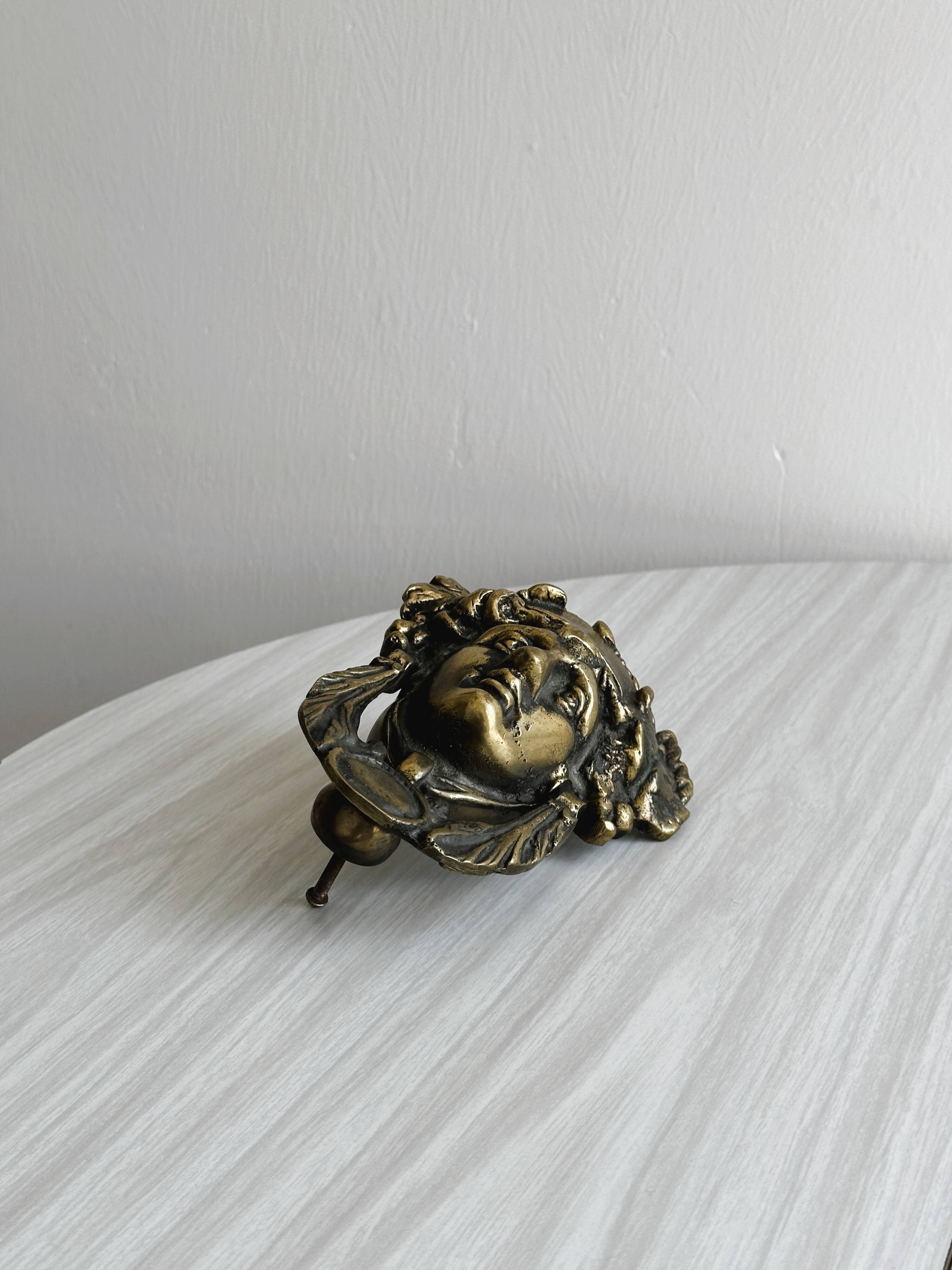 Large antique style brass metal knocker.