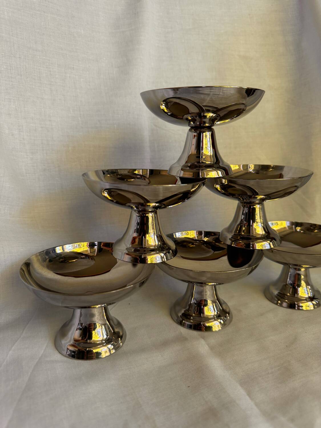 Set of 6 stainless steel ice cream bowls by Guy Degrenne with matching spoons.