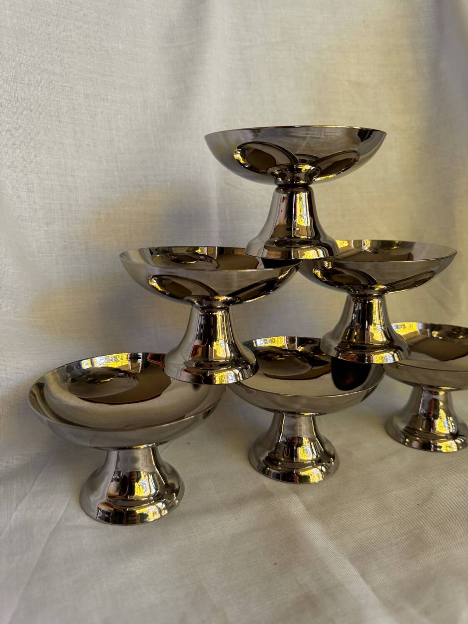 Set of 6 stainless steel ice cream bowls by Guy Degrenne with matching spoons.