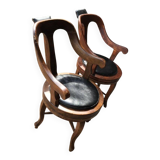 Pair of antique brown swivel armchairs in upholstery fabric, wooden frame, Hungary circa 1900.