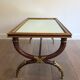 Coffee table in patinated and gilded carved wood with mirror top