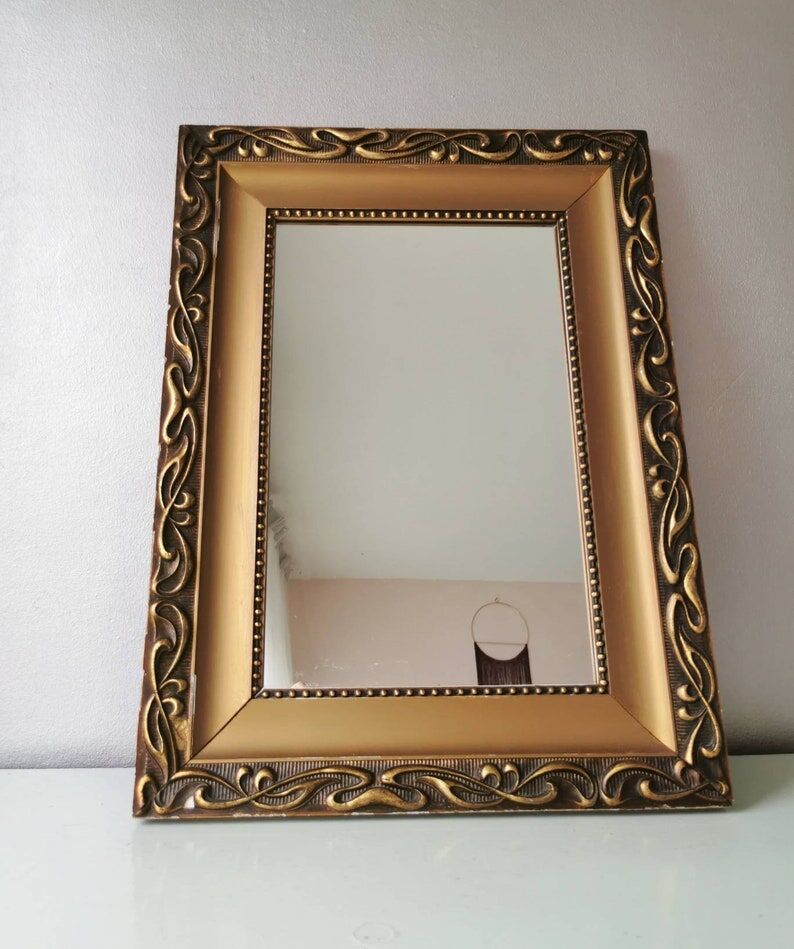 Beautiful French vintage mirror in gilded wood from the 60s