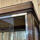 Early 20th-century shop display cabinet in oak with sliding doors.