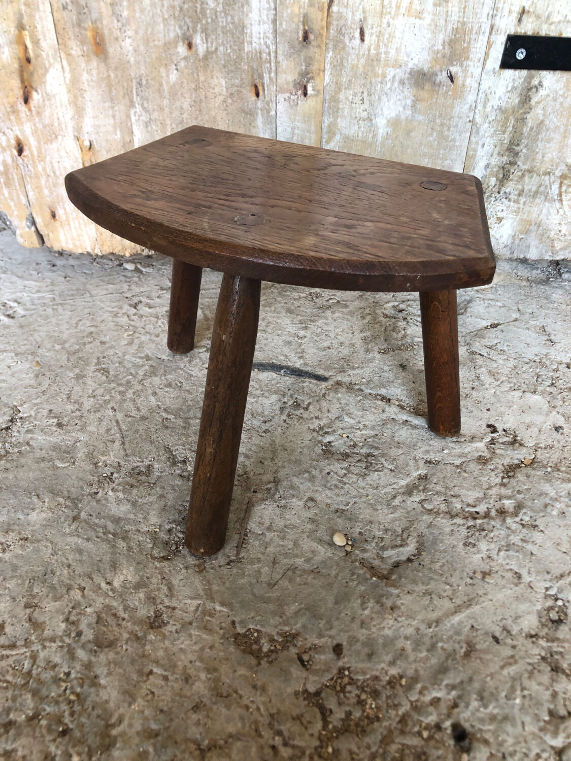 Old vintage wooden tripod milking stool