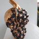 Beautiful black and gold ceramic bottle in the shape of a bunch of grapes.