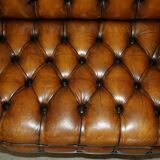 Vintage Chesterfield serpentine luxury sofa in restored leather