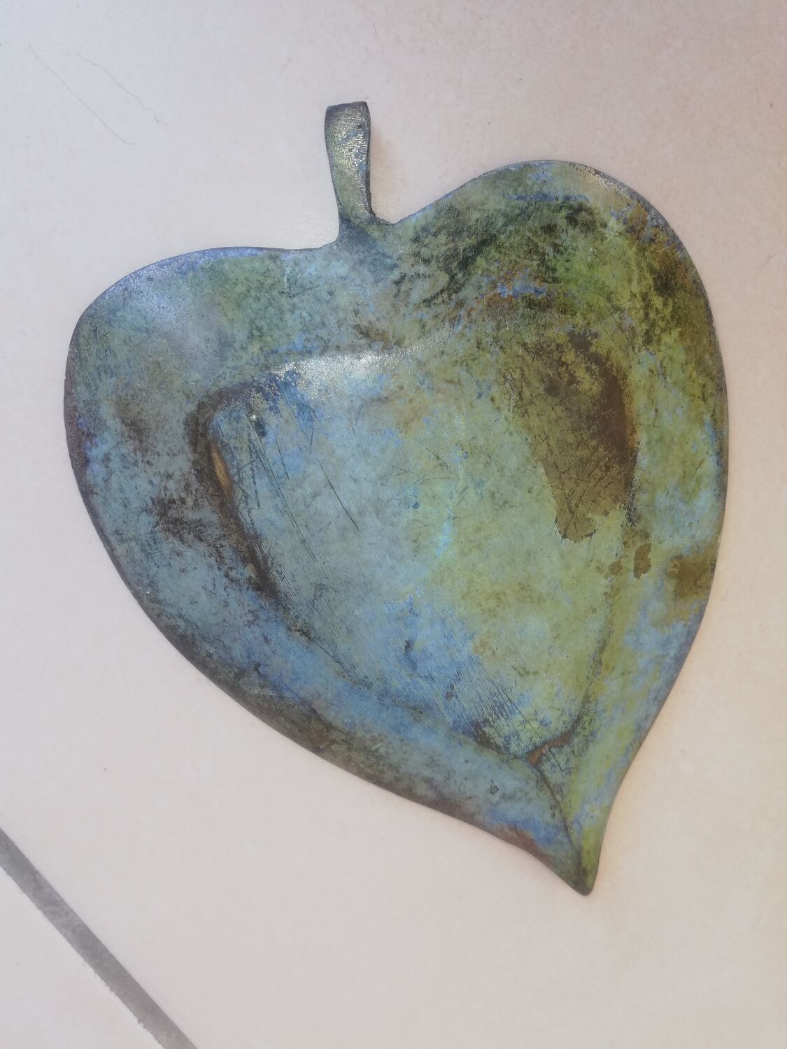 Greenish metal leaf pocket emptier