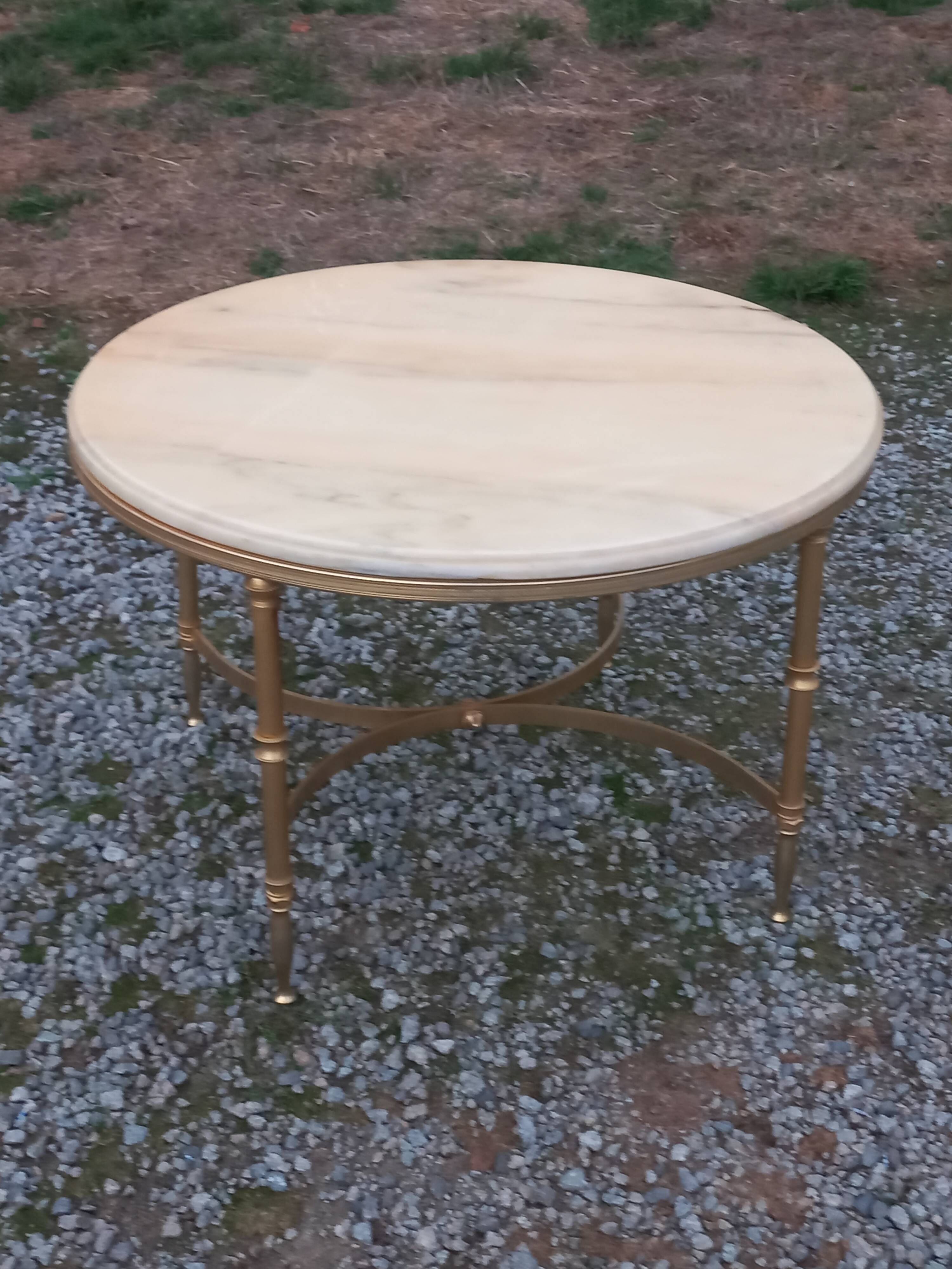 Round neoclassical coffee table with a marble top and golden metal base.