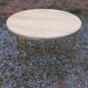 Round neoclassical coffee table with a marble top and golden metal base.