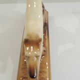 Beige and brown ceramic representing a “Greyhound/vintage 1930
