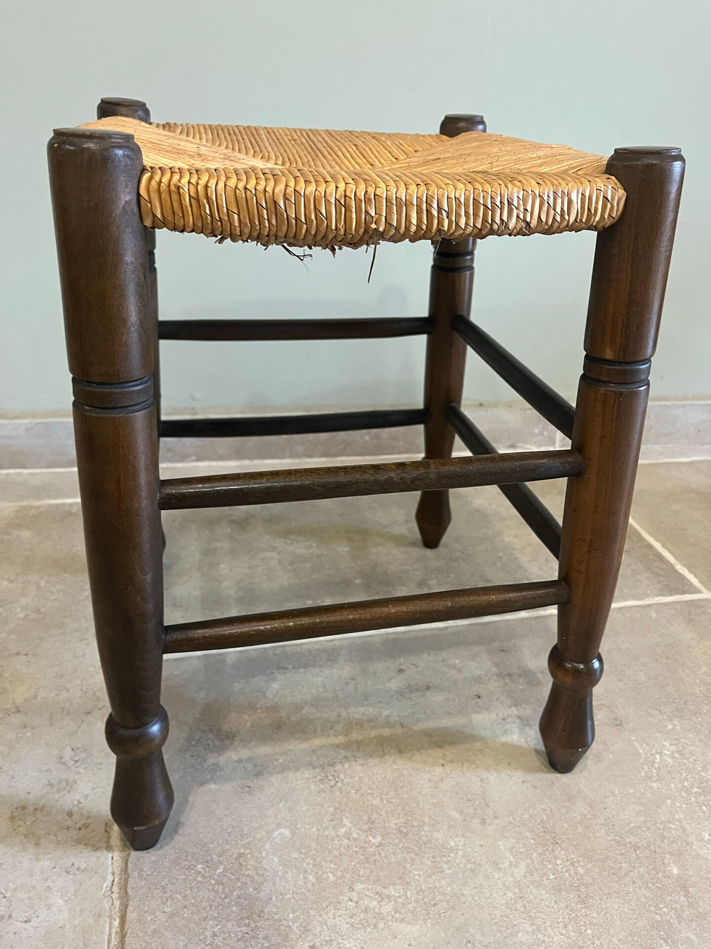 Wooden stool with a straw seat