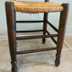 Wooden stool with a straw seat