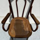 Thonet armchair stamped with curved wooden armrests and caning from the 19th century.