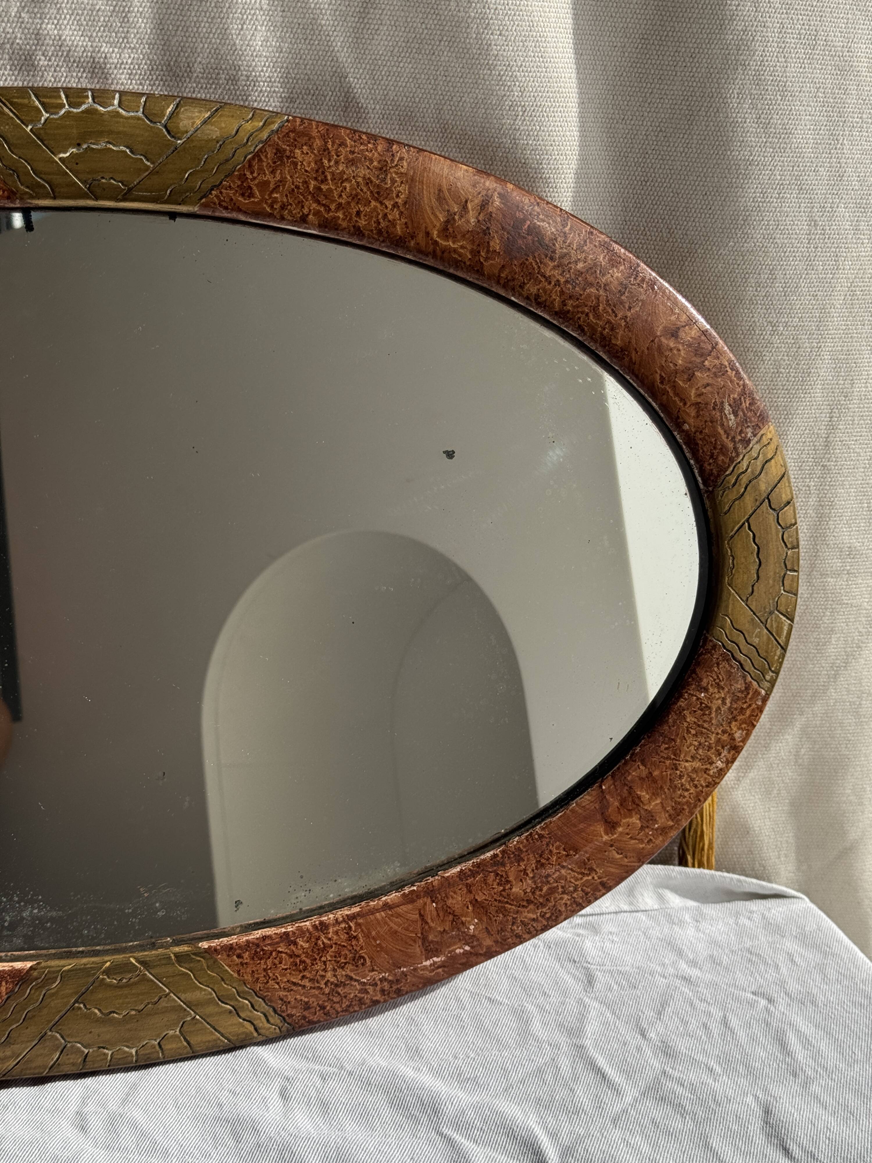Small oval Art Deco mirror in brown and gold 33x54.