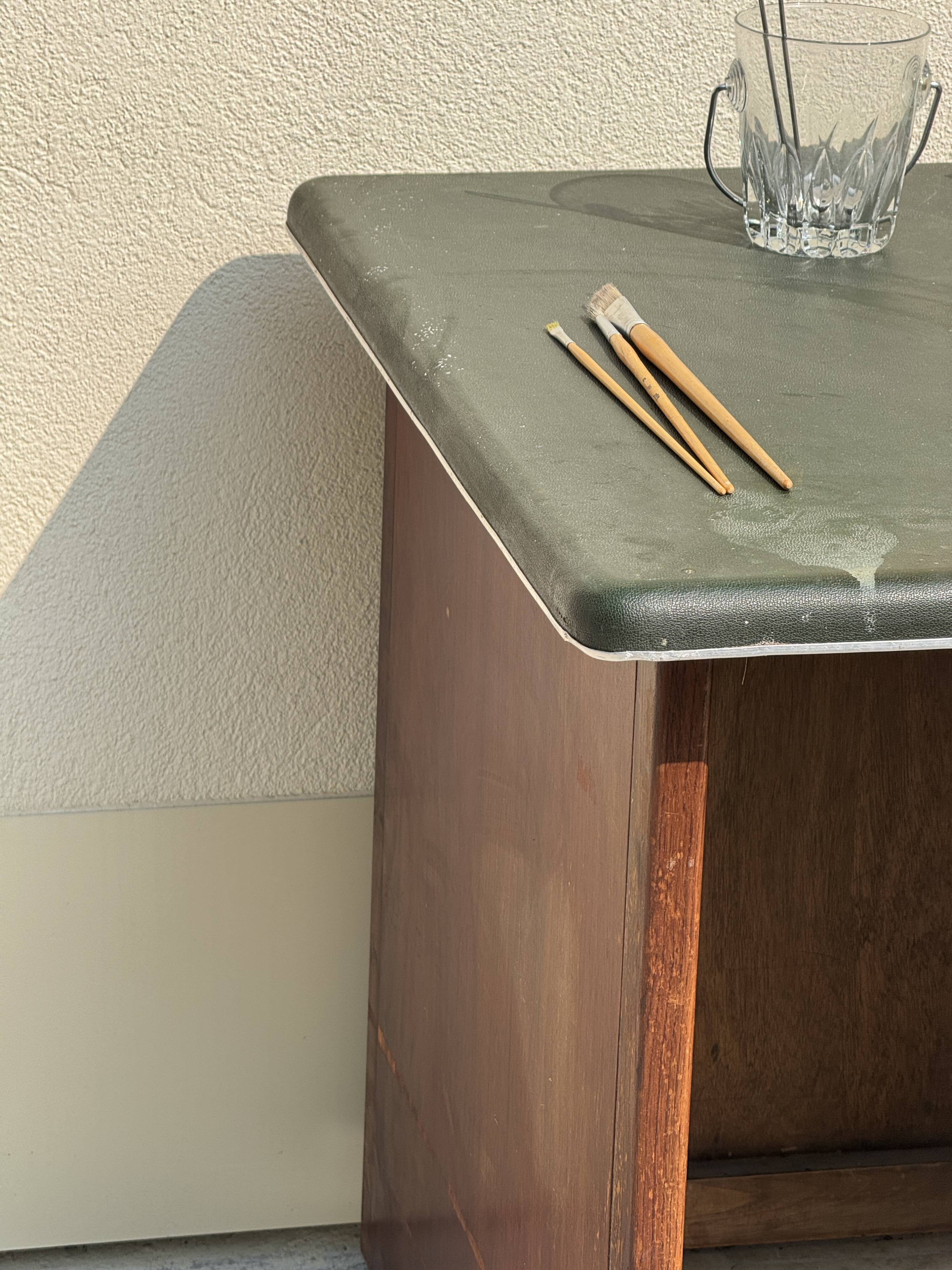 Modernist desk in wood and green moleskin upholstery