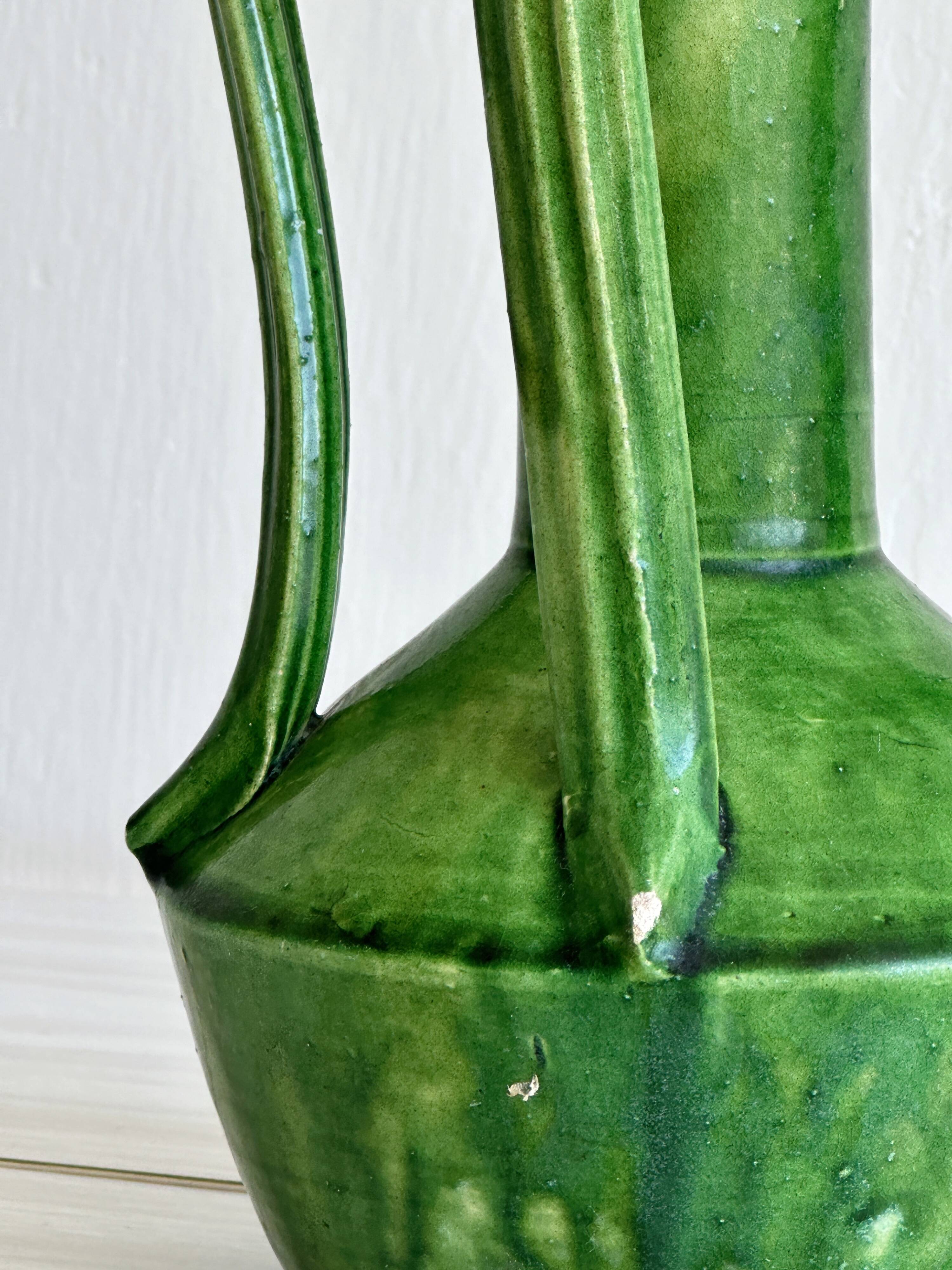 Pottery green ceramic vase with four handles.