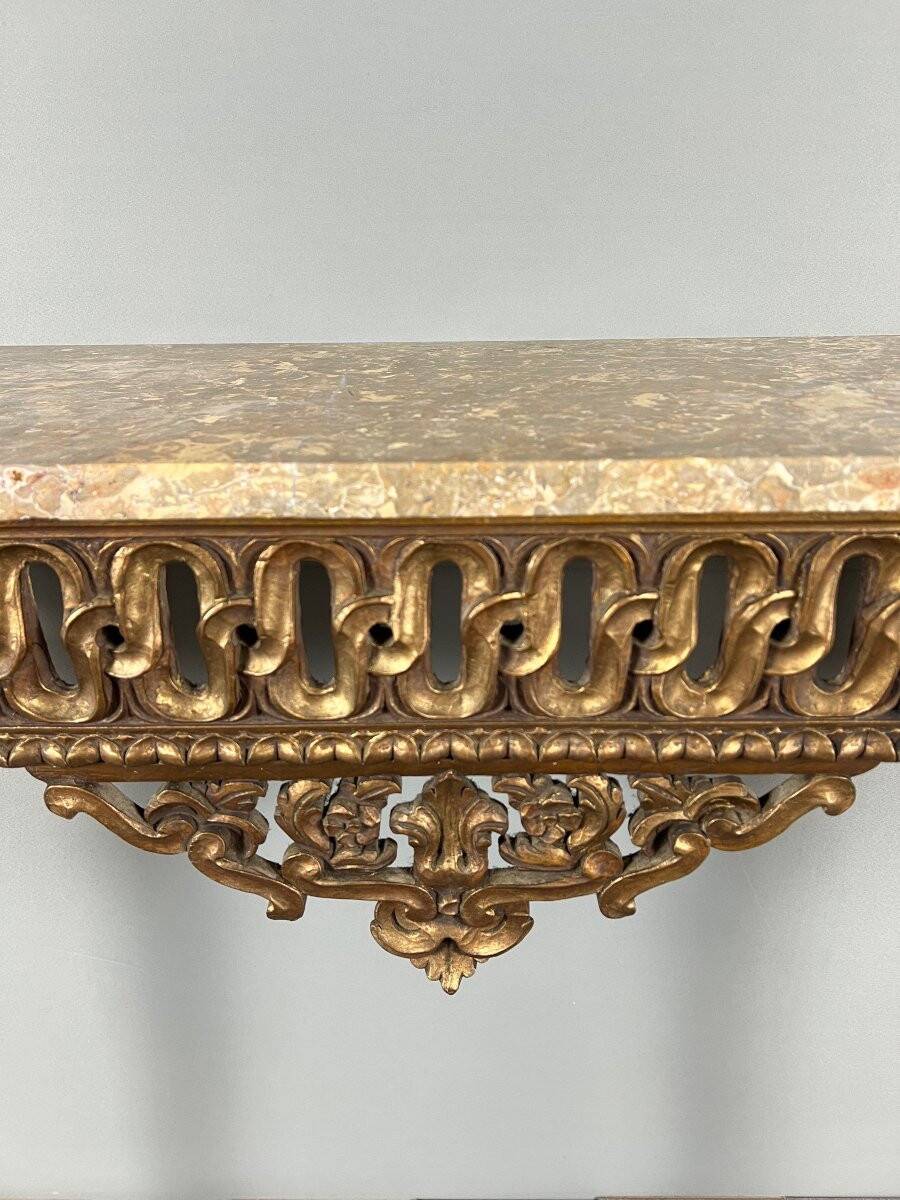 Louis XVI style console in carved wood with a gilded patina, 19th century.