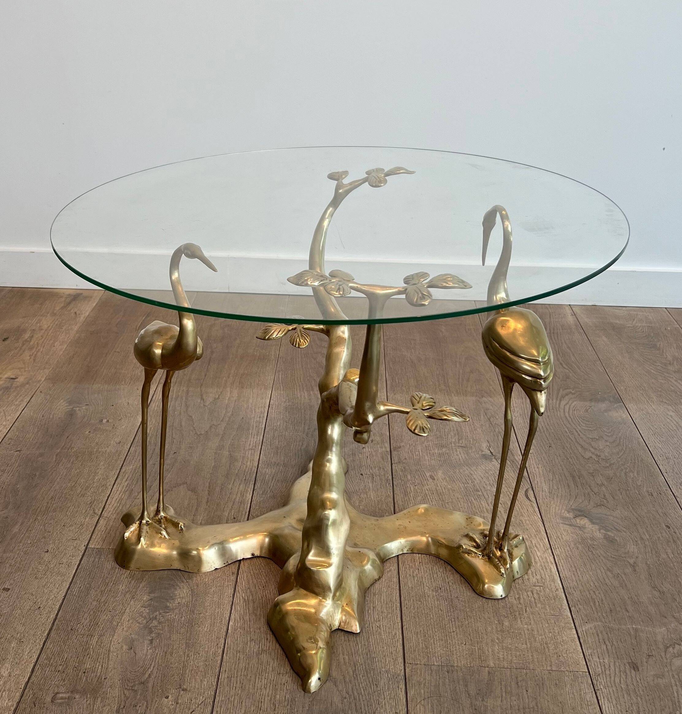 Coffee table model with cranes surrounding a brass bonsai and round glass top by Willy Daro.