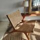 Reclining armchair in natural wood and woven rattan