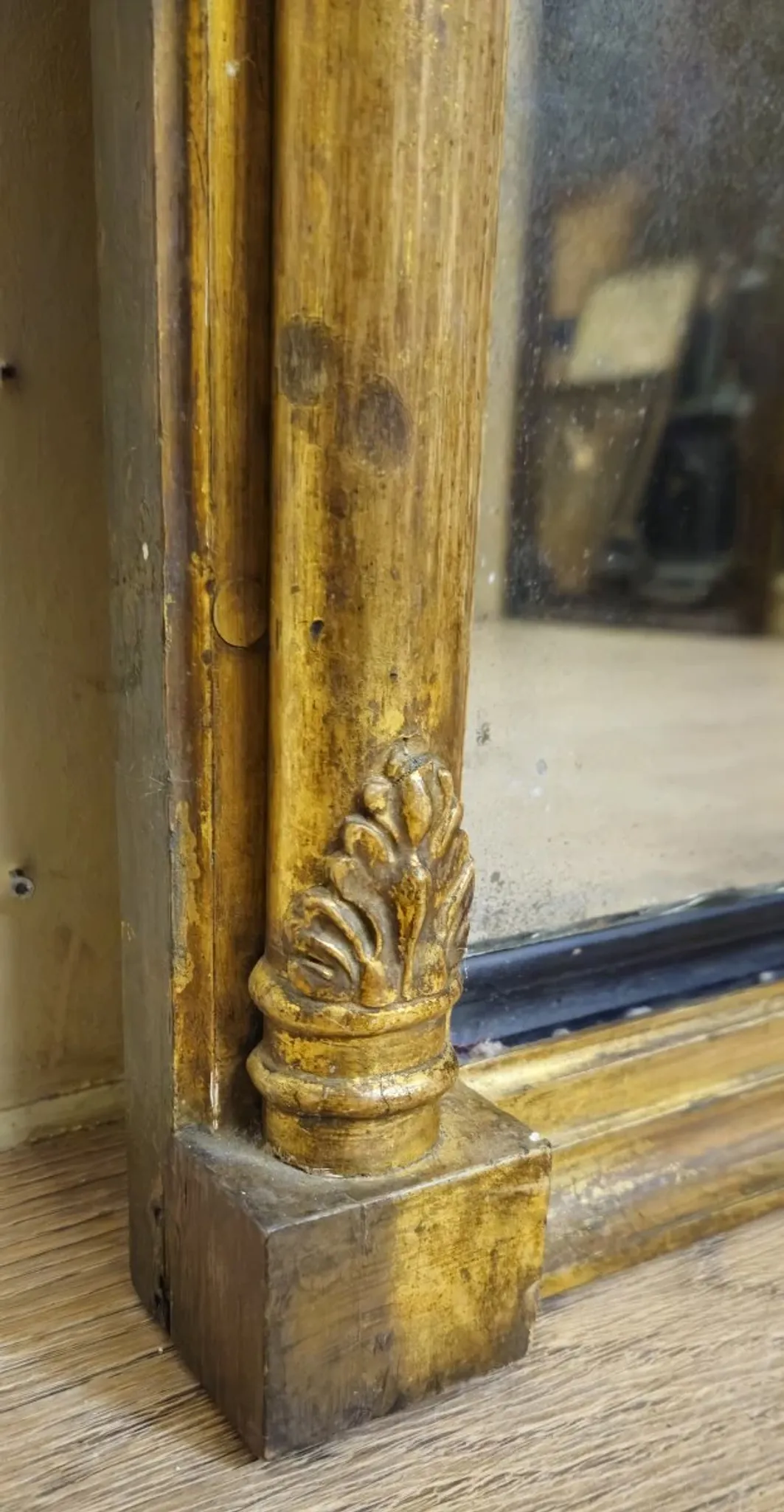 Large antique gilded wooden mirror with terracotta relief from the Empire period.