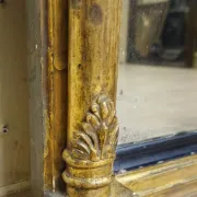 Large antique gilded wooden mirror with terracotta relief from the Empire period.